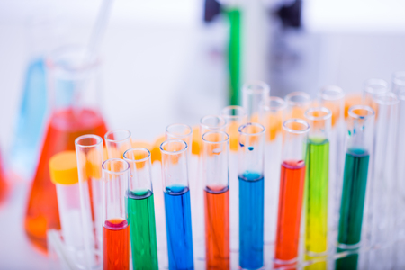 Test tubes, microscope,  and beakers on lab tableの写真素材