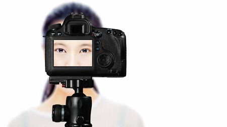Focus on live view on camera on tripod, teenage girl  beauty shoot image on back screen with blurred...