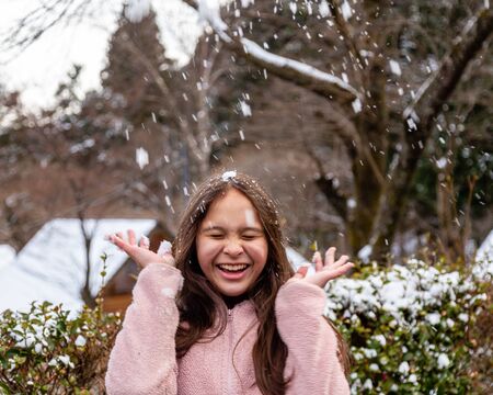 Young tween girl having fun in snowの写真素材