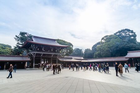 TOKYO, JAPAN - FEBRUARY 7, 2019: Crowds of tourists in Meiji Shrine in Shibuya, Tokyo. The shrine is...