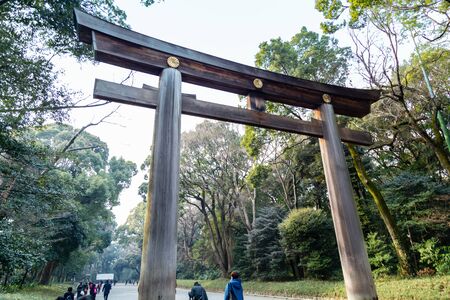 TOKYO, JAPAN - FEBRUARY 7, 2019: Crowds by torii gate of Meiji Shrine in Shibuya, Tokyo. The shrine is officially designated Kanpei-taisha, the 1st rank of government supported shrines.のeditorial素材