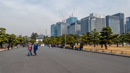 TOKYO, JAPAN - FEBRUARY 7, 2019: People in line to buy tickets to Tokyo Imperial Palace  Kikyomon...