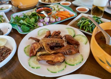 Selection of burmese dishes in rural Myanmar with skinny chicken and traditional soupの写真素材