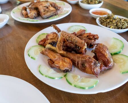 Selection of burmese dishes in rural Myanmar with skinny chicken and traditional soupの写真素材