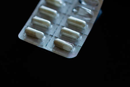 Tablets in blister pack on black backgroundの写真素材