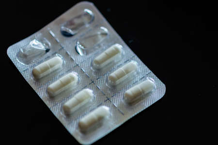 Tablets in blister pack on black backgroundの写真素材