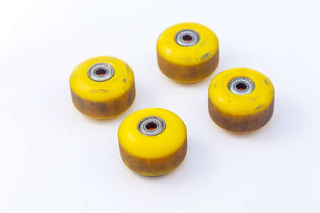 Yellow skateboard wheels on white backgroundの写真素材