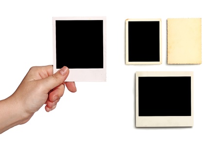 Isolated close-up shot of a human hand holding instant photo. More elements on side