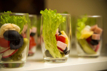 Refreshing salad starter served in small glasses on baquet dinnerの写真素材