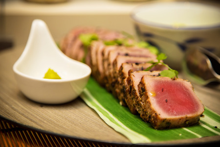 Seared tuna steak called Sashimi traditional Japanese dish with wasabi sauceon sideの写真素材
