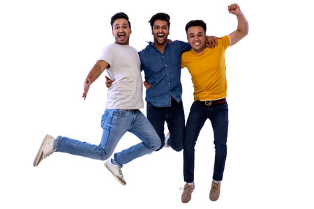 Three guys are smiling while jumping in the air and hugging.の写真素材