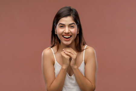 Portrait of a beautiful young asian woman laughing and looking at cameraの写真素材