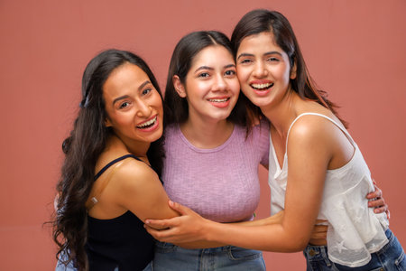 Portrait of three happy young women looking at camera and smiling.の写真素材