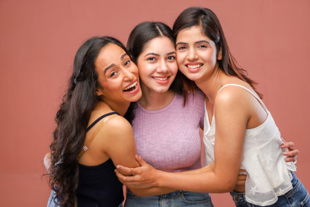 Portrait of a group of young asian women smiling and huggingの写真素材