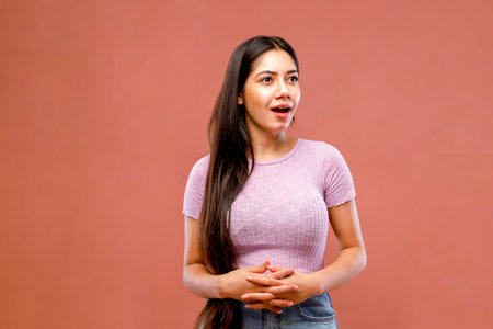 Portrait of a beautiful latin woman on a pink background.の写真素材