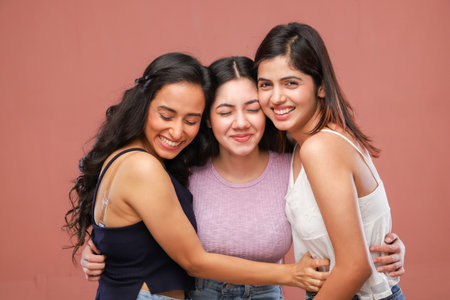 Portrait of three young asian women smiling and hugging each otherの写真素材