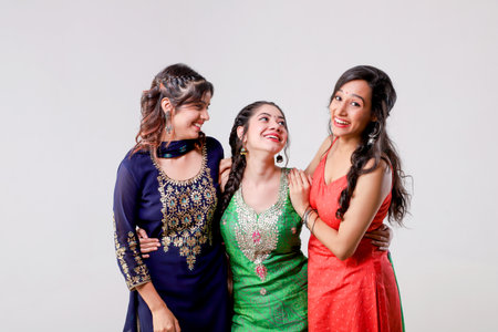 three indian women in saree on white background, studio shotの写真素材