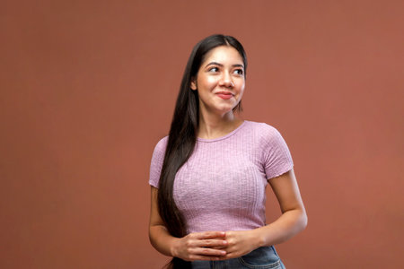 Portrait of a beautiful young latin woman on a brown backgroundの写真素材