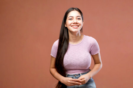 Portrait of a beautiful young brunette woman on a brown backgroundの写真素材