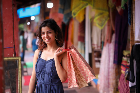 Young woman with shopping bags in the street of Kolkata, Indiaの写真素材