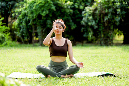 Portrait of a young woman meditating in the park. Yogaの写真素材