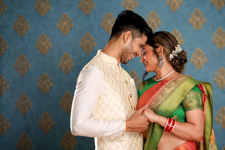 Beautiful indian couple in traditional clothes, bride and groom huggingの写真素材