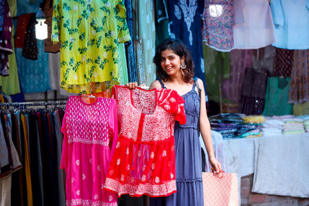 Beautiful young indian woman shopping in the street market. Indiaの写真素材