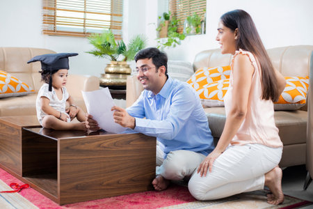 Portrait of happy family sitting on carpet in living room at homeの写真素材