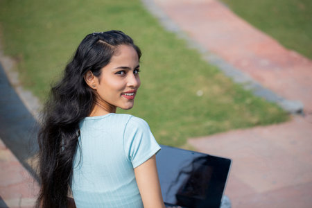 Young woman using laptop in the park.の写真素材
