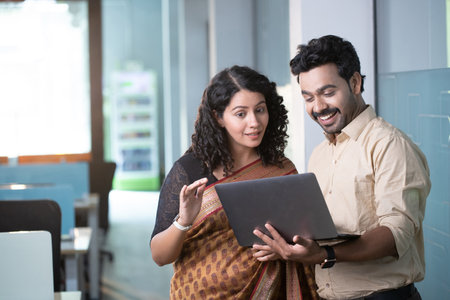Indian businessman and businesswoman using laptop computer in creative office. Indian peopleの写真素材