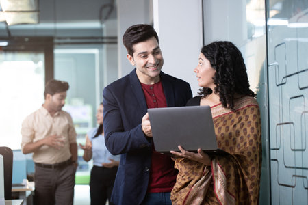 Portrait of Indian business people discussing over laptop in meeting room at officeの写真素材