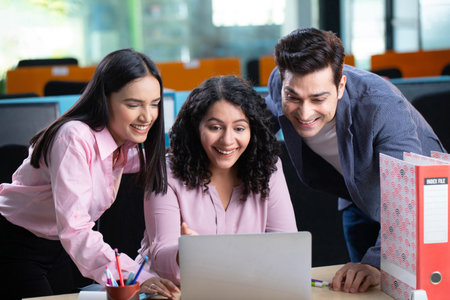 Portrait of happy business people working together at office desk and smiling