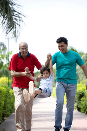 Three generation asian family spending time together in the park. Father, mother and son having fun together.の写真素材