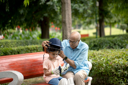 Elderly man and his grandson wearing protective mask in the parkの写真素材