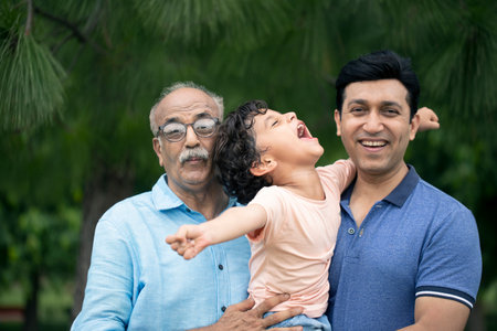 Portrait of Indian asian grandfather and grandchild in the parkの写真素材