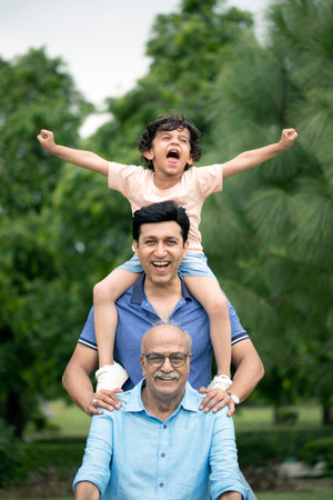 Grandfather and grandson having fun together in the park. Concept of happy family.の写真素材