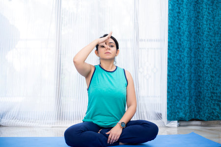 Portrait of a young attractive woman doing yoga at home. Yoga concept.