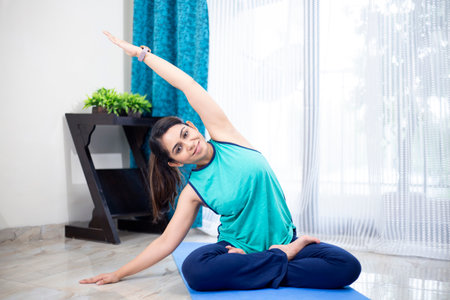 Beautiful young woman doing yoga exercise at home. Yoga concept.