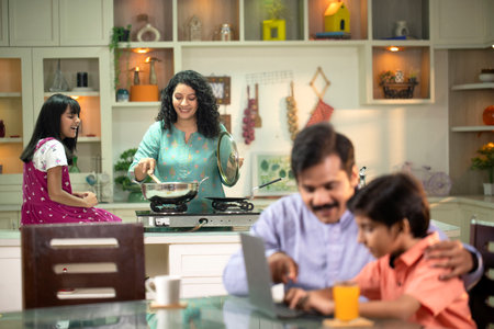Indian family cooking at home in the kitchen. Happy family concept.の写真素材