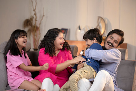 Happy family spending time together on the sofa in the living room at homeの写真素材