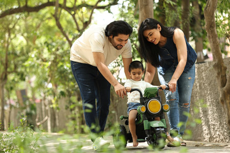 Happy family playing in the park. Father, mother and son having fun together.の写真素材