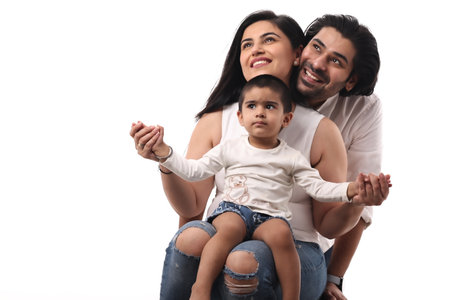 Happy young family with one child on a white background. Studio shot.の写真素材