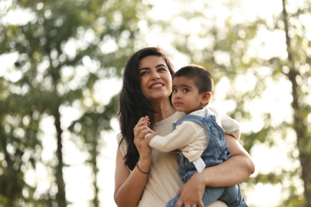 Mother and son playing in park on summer day. Concept of friendly familyの写真素材