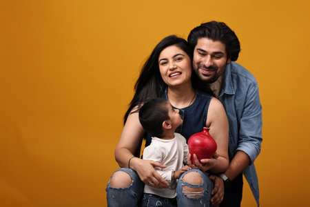happy indian family with red piggy bank on yellow background.