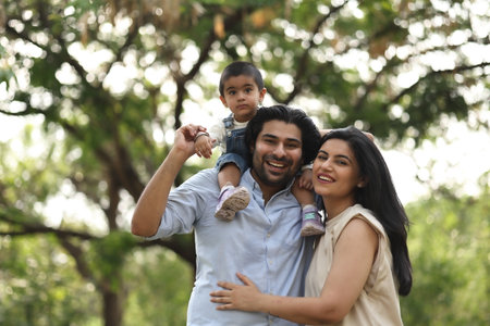 happy young family have fun and relax while take care of their childの写真素材