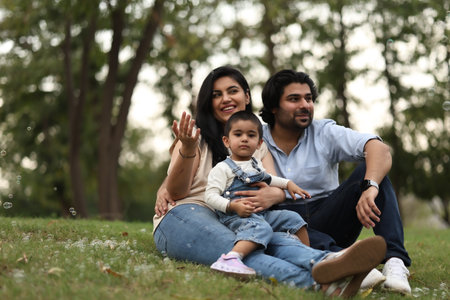 happy young family in love have fun and relax at beautiful green park outdoorの写真素材