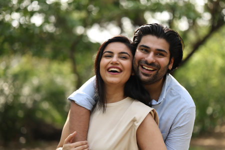 Portrait of happy young couple in love outdoors, focus on manの写真素材