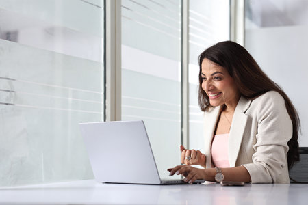 Beautiful businesswoman working with laptop in office. Space for textの写真素材
