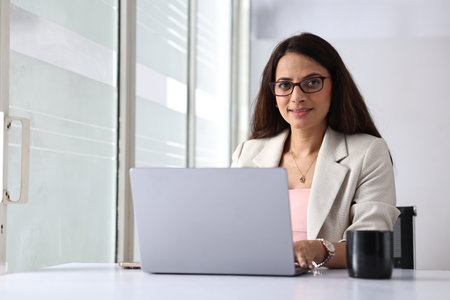 Portrait of businesswoman working on laptop in office. Business conceptの写真素材