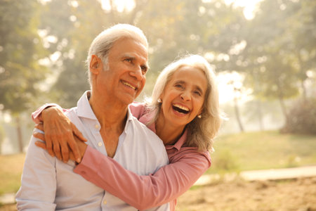 Happy senior couple in park on summer day. Focus on elderly woman